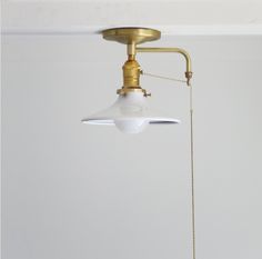 a white light hanging from the ceiling in a room