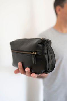 Natural grain leather toiletry bag, lined with cotton fabric. Wide-open interior for easy access to toiletries and other daily essentials. Featuring two zippered exterior pocket. Leather Toiletry Bag, Leather Dye, Daily Essentials, Vegetable Tanned Leather, Toiletry Bag, Small Bags, Easy Access, Black And Brown, Grain