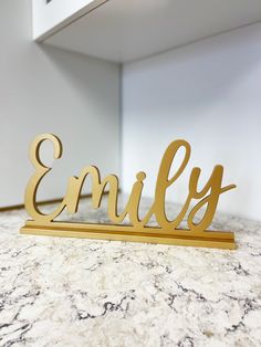 a wooden name sign sitting on top of a counter