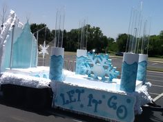 an ice sculpture with snow flakes on it and the words let it go written in blue