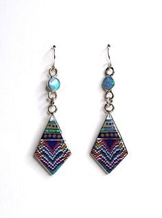 "Brand new high quality handcrafted earrings with genuine natural multicolor inlay stones on 925 sterling silver and stamped 925. The stones consist of Spiny oyster, Lapis, Fire Opal, coral and Mother of Pearl. Our silver is genuine 925 sterling silver. The earrings measures 2.5\" long and 3/4'' wide. The round stone on the top are 6mm. You will receive the item in a gift box Thanks for looking and check out more items in my Etsy shop for more great items and deals! https://www.etsy.com/shop/925 Sterling Silver Multi-stone Teardrop Earrings, Sterling Silver Drop Earrings With Inlay, Sterling Silver Inlay Drop Earrings, Artisan Multicolor Long Drop Jewelry, Nickel-free Multicolor Sterling Silver Earrings, Sterling Silver Dangle Earrings With Inlay, Silver Dangle Earrings With Inlay, Iridescent Sterling Silver Bohemian Jewelry, Multicolor Sterling Silver Nickel-free Earrings