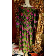 This elegant dress is from the 70's and was custom made for it's original owner. Made of a luxurious Dupioni Silk. Deep green back ground with hot pink floral print.  Blouson top tha sits at the edge of the shoulders. Nipped waist and slightly full long skirt.  Fully lined in olive green silk.  This is expertly made and excellent condition. Best fit would be a Medium, however, please see the measurements below for a proper fit. All sales are final. Measurements Armpit-armpit doubled 40" Waist 28" Hip 48" Length 54" Green Retro Cocktail Dress, Vintage Long Sleeve Green Dress, Vintage Silk Dress With Floral Print, Retro Pink Silk Dress, Pink Retro Silk Dress, 1970s Style Floral Print Dress For Garden Party, Pink Silk Retro Dress, 1970s Style Green Floral Print Dress, 1970s Vintage Spring Maxi Dress