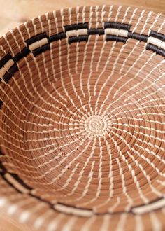 a woven basket sitting on top of a wooden table