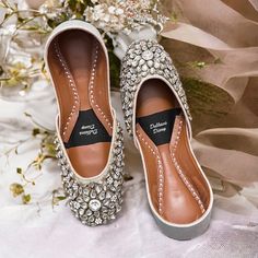 Introducing our Handmade Bridal Kundan Khussa with Crystal Embellishments - the epitome of elegance and comfort for your special day. 🌟 Embrace the Charm: Crafted with love and attention to detail, our bridal Khussa shoes are a perfect fusion of tradition and modern aesthetics. The delicate crystal embellishments add a touch of sparkle that will make you shine on your wedding day. 👑 Regal Comfort: We understand that every bride deserves to feel like royalty. That's why our Khussa shoes come wi Crystal Embellished Flats For Wedding, Silver Round Toe Flats For Wedding, Party Flats With Mirror Work And Round Toe, Wedding Flats With Gota Work And Round Toe, Festive Wedding Shoes With Round Toe, Embellished Closed Toe Wedding Shoes, Wedding Flats With Gota Work, Embellished Flat Heel Wedding Shoes For Reception, Embellished Round Toe Wedding Shoes