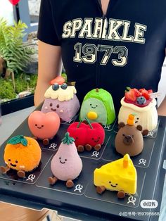 a person standing in front of a table with small cakes on it