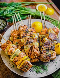 grilled meat and vegetables on skewers with lemons