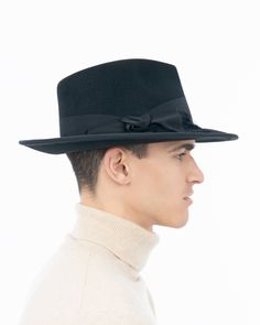 The highest quality materials are used for this sophisticated unisex fedora. It is hand blocked of luxurious super felt and has a grosgrain band finishing to one side in a fringed bow knot. The Crown is lined. The elasticized inner band fits most. Imported. Brim Span: 3" Straw Visor, Fedora Hat Men, Winter Bags, Rain Hat, Band Fits, Hat For Men, Straw Bags, Bow Knot, Leather Hats