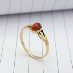 Product:-Ring Material:- Brass Gemstone;- Carnelian Gold Carnelian Ring,Handmade Carnelian Ring,Unique Ring,Boho Ring,Hand Holdig Carnelian Gemstone Ring,Minimalist Ring,Gift Ring,Promise Ring ❥ Customers' satisfaction is our biggest priority, please contact us with any questions/queries for future or existing orders, and we will do our best to make sure you are happy with your order. ❥Please make sure to add the correct address during checkout. You can return your purchased item within 15 days Amber Carnelian Ring With Cabochon, Antique Carnelian Ring As A Gift, Antique Carnelian Ring As Gift, Antique Carnelian Rings For Gifts, Antique Carnelian Ring For Gift, Handmade Carnelian Amber Rings, Handmade Amber Carnelian Rings, Vintage Carnelian Gemstone Rings, Spiritual Carnelian Cabochon Rings