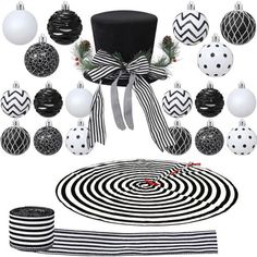 black and white christmas decorations are arranged in the shape of a hat, balls, and ribbon