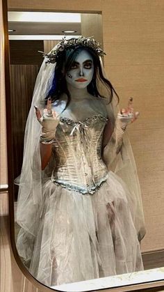 a woman dressed as corpse bride in a mirror