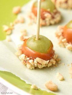 small appetizers with green olives and walnuts on a paper plate, ready to be eaten