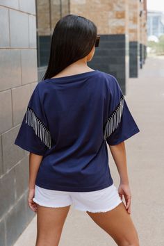 Every day is game day with our Dallas Cowboys short sleeve rhinestone fringe tee with ribbed neckline. From the game to the everyday, this is your go-to choice. Casual Short Sleeve Fringe T-shirt, Casual Cotton T-shirt With Fringe, Cotton Fringe Short Sleeve Tops, Casual Crew Neck T-shirt With Fringe, Casual Short Sleeve Tops With Tassels, Fringe Tee, Rhinestone Fringe, Ribbed Neckline, Dallas Cowboys