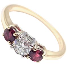 18k Yellow Gold and Platinum Diamond And Ruby Three Stone Band Ring by Tiffany & Co. With 1 Round Brilliant Cut Diamond VS1 clarity, G color, Total weight Approx .50ctw 2 Round rubies total weight approx. 0.50ct Details: Ring Size: 6 Width: 6mm Weight: 2.7 grams Stamped Hallmarks: Tiffany&Co 750 PT950 **Free Shipping within the United States** Your Price: $7,500 T2697oddd Luxury Ruby Three Stone Rings, Luxury Multi-stone Round Cut Ruby Ring, Luxury Ruby Ring With Multi-stone Round Cut, Luxury Red Three Stone Jewelry, Luxury Round Cut Multi-stone Ruby Ring, Luxury Red Three-stone Jewelry, Classic Ruby Diamond Multi-stone Ring, Elegant Three Stone Diamond Ruby Ring, Luxury Gold Three-stone Ruby Ring