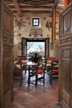 an open door leading to a dining room with red chairs and wooden tables in it