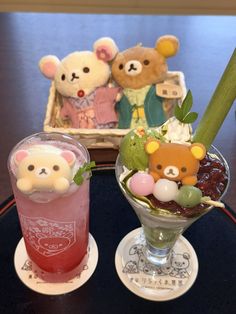 there are two drinks on the table and one is decorated with teddy bear figurines