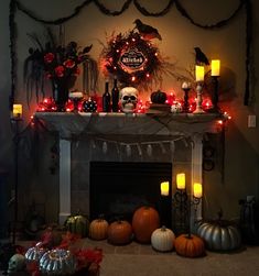 a fireplace decorated with halloween decorations and candles