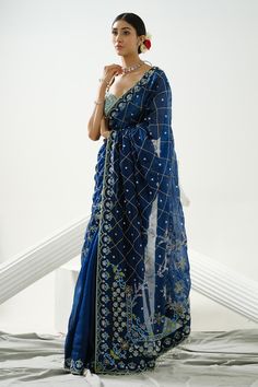 Dark blue saree with sequin, cutdana, bead embroidery in geometric pattern. Paired with sea blue blouse.
Components: 2
Pattern: Embroidery
Type Of Work: Sequin, cutdana, bead, geometric
Neckline: Sweetheart neck
Sleeve Type: Cap sleeves
Fabric: Organza
Color: Blue
Other Details: 
Crystal drops
Back tie-up knot
Occasion: Wedding - Aza Fashions Dark Blue Sequin Saree, Dark Blue Saree For Farewell, Blue Indian Outfit, Peacock Blue Saree, Dark Blue Saree, Sari Designs, Lengha Sari, Royal Blue Saree, Blue Sari