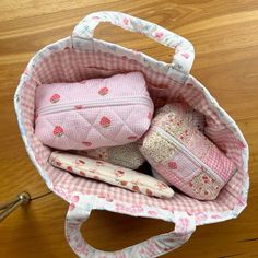 a pink purse sitting on top of a wooden floor