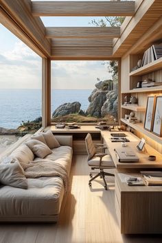 a living room filled with furniture next to an ocean side cliff overlooking the water's edge