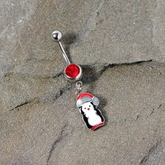 Red Gem Holiday Penguin Christmas Dangle Belly Ring Get ready for cool winter weather this holiday season when you wear this 14 gauge Christmas belly button ring. Made with a 3/8" durable 316L surgical grade stainless steel curved barbell, this navel piercing features a red bottom gem and penguin dangle charm with a red winter hat too!Specifications14 Gauge (1.6mm), 3/8" (10mm), 316L Surgical Grade Stainless Steel Curved Barbell Dainty Gold Jewelry, Penguin Christmas, Dangle Belly Rings, Cool Winter, Red Bottom, Navel Piercing, Belly Button Ring, Belly Piercing, Button Ring