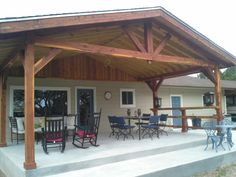 an outdoor covered patio with chairs and tables