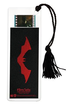 a bookmark with a red design on it and a tassel attached to it