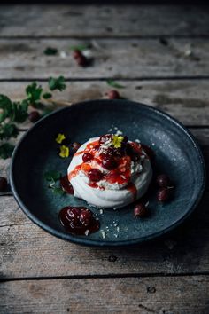 a plate with some food on it and garnished with cherries in the center