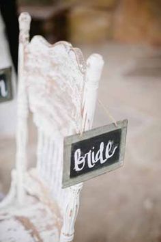 a white chair with a sign that says bride on it