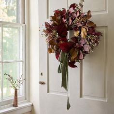 a wreath is hanging on the front door