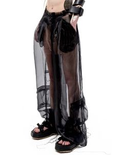 RELAXED-FIT WIDE-LEG LIGHTWEIGHT SEMI-SHEER ORGANZA CARGO PANTS IN BLACK WITH ETHEREAL EFFECT. BELT LOOPS. ZIP-FLY. CONCEALED VELCRO FASTENING AT FRONT WAISTBAND. DARTS AT BACK. 6-POCKET STYLING. LOOSE THREAD OVERLOCK ROOTS DETAILING THROUGHOUT. *MIX WITH SHORTS/LEGGINGS/HALF SKIRT WAIST BAG TO REACH OPACITY, BUT KEEP ETHEREAL EFFECT OF THE LOOK.COMPOSITION & CARE:BODY: ORGANZA100% POLYESTER DRY CLEAN ONLY. MEDIUM TEMP IRON. DO NOT BLEACH.MADE IN UKRAINE MODEL ANDRA IS 5FT 9" (175CM) TALL, CHEST Sheer Black Bottoms, Black Sheer Pants For Spring, Sheer Black Full-length Bottoms, Alternative Style Black Stretch Bottoms, Alternative Style Stretch Black Bottoms, Alternative Black Stretch Bottoms, Alternative Style Black Trousers, Black Sheer Pants For Night Out, Alternative High Waist Black Bottoms