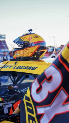 a yellow race car with a helmet on top