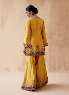 Editor's Note Presenting a luxurious mustard kurta sharara adorned with intricate floral thread embroidery, elegantly highlighted with velvet patchwork and various embellishments. This opulent ensemble is paired with an embroidered dupatta, creating a regal and elegant look perfect for special occasions or festive gatherings. The combination of the rich mustard color, the velvet details, and the ornate embroidery on both the kurta sharara and dupatta adds a touch of grandeur, making this outfit Marriage Suit, Embroidery Kurta, Velvet Patchwork, Kurta Sharara Set, Satin Suit, Kurta Sharara, Classy Suits, Punjabi Outfits, Boutique Suits