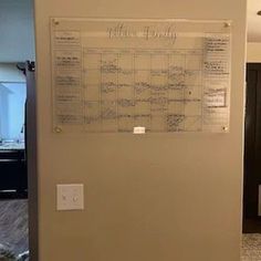 a large white board mounted to the side of a wall next to a bathroom sink