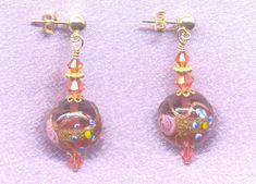 "Vintage Italian Wedding Cake Beads, Rubino Pink Fiorato, Murano Glass Earrings, handmade with 14mm Round, Venetian Beads. These detailed Italian, lamp worked beads are made with Rubino Pink colored Murano glass, Aventurina (copper), pink \"roses\", and blue and yellow \"forget-me-knots\". Some people refer to these beads as \"wedding cake\" beads; but the Italians call these beads \"Fiorato\" (flowered). I refer to them as Antique Fiorato. The Rubino dangle earrings are shown in the photo on go Pink Round Jewelry With Bead Caps, Gold Beaded Earrings With Round Beads For Wedding, Gold Beaded Earrings For Wedding, Pink Beaded Earrings For Weddings, Czech Glass Round Jewelry For Wedding, Wedding Beaded Earrings With Round Beads, Round Beaded Earrings For Wedding, Pink Spacer Beads Wedding Jewelry, Pink Spacer Beads Jewelry For Wedding