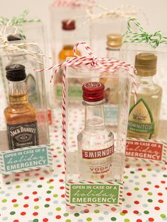 four miniature liquor bottles are sitting on a table