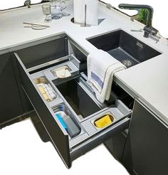 an open drawer in the middle of a kitchen counter