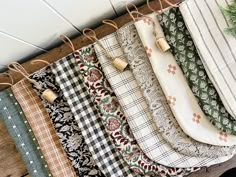 an assortment of fabrics hanging on a wall