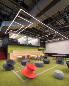 an office with green carpet and red chairs