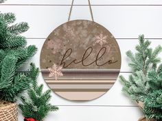 a christmas ornament hanging on the side of a wall next to potted plants