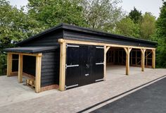 a black building with wooden posts and doors