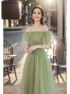 a woman in a green dress posing for the camera