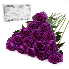 a bunch of purple roses sitting next to a card