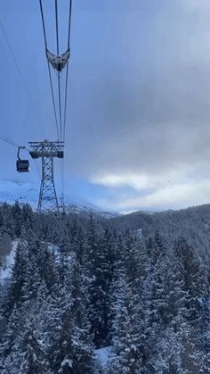 a ski lift going up the side of a snow covered mountain