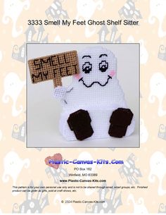 a crocheted ghost with a sign that says smile my feet shelf sitter