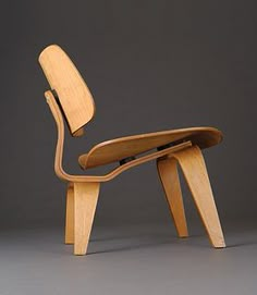 an eames chair and ottoman made out of plywood wood with the seat folded down