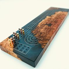 a wooden board game with several pieces on it