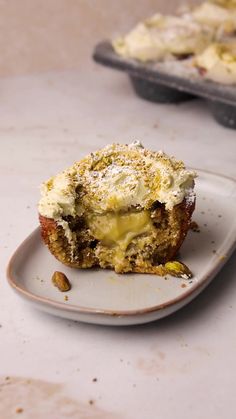 an egg muffin on a plate with some other food in the background