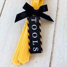 yellow toothbrushes with black ribbon tied around them