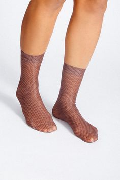 Go from office to loungewear with this lightweight and silky pair of hosiery. These silk socks are composed of a nylon blend and a reinforced toe-heel for added comfort. Size: + OSFA, W 7-10 Design: + 200 Needle + Lightweight + Breathable & flexible + Seamless toe + Ankle Content + Care: + Premium Silk Hosiery + Wash Cold/Dry Low Micro-elastic Sheer Nylon Stockings, Sheer Fitted Nylon Socks, Fitted Nylon Elegant Socks, Stretch Mesh Fishnet Socks, Stretch Fishnet Socks Made Of Mesh, Stretch Fishnet Mesh Socks, Stretchable Fishnet Mesh Socks, Trendy Fitted Nylon Socks, Silk Socks