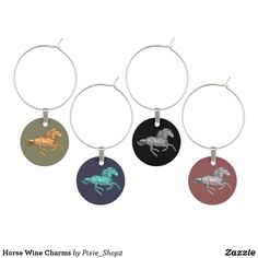 four wine charms with horses on them in different colors and sizes, all hanging from the same metal hoop